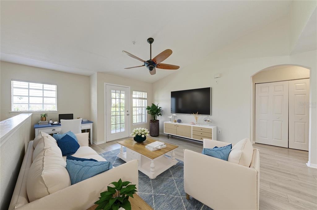 8911 Manor Loop, Unit 207 Lakewood Ranch, FL 34202 - Photo 15 of 71 a living room with furniture and a flat screen tv