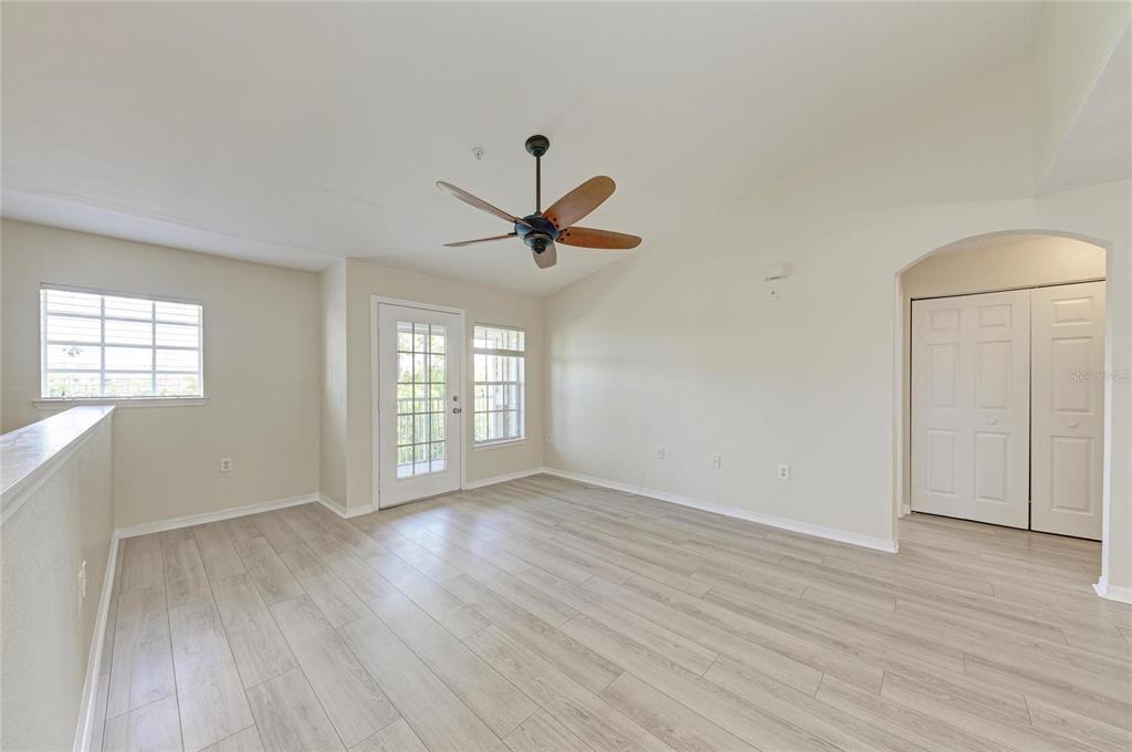 8911 Manor Loop, Unit 207 Lakewood Ranch, FL 34202 - Photo 16 of 71 wooden floor in an empty room with a window