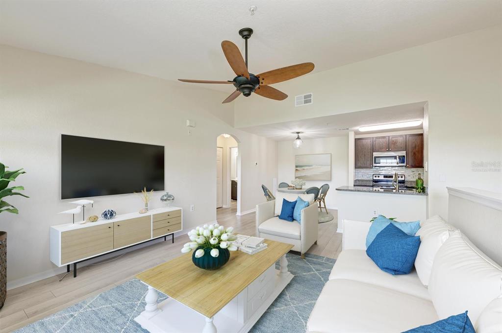 8911 Manor Loop, Unit 207 Lakewood Ranch, FL 34202 - Photo 19 of 71 a living room with furniture and a flat screen tv