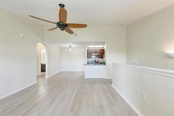 a kitchen with granite countertop a refrigerator and a stove top oven