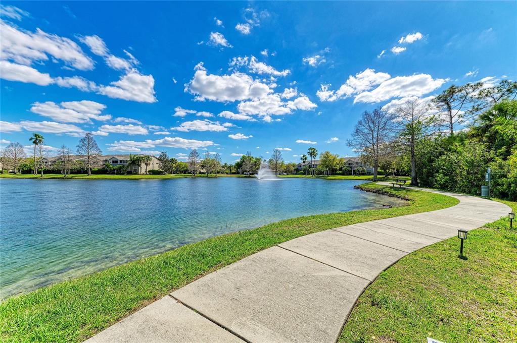 8911 Manor Loop, Unit 207 Lakewood Ranch, FL 34202 - Photo 2 of 71 a view of a lake with houses in the back