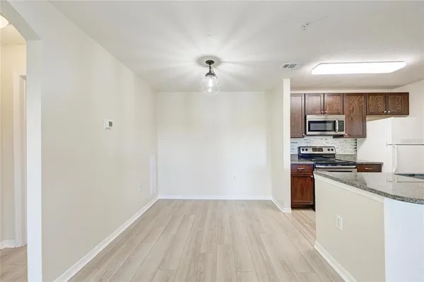 a kitchen with stainless steel appliances a refrigerator and a stove top oven