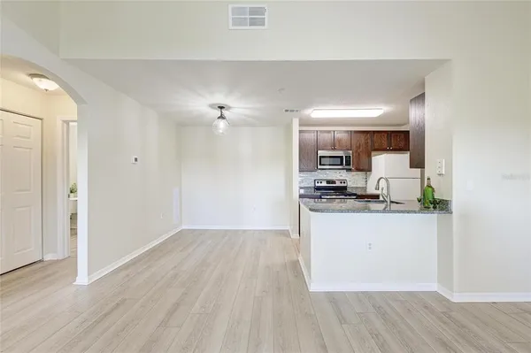 a kitchen with granite countertop a sink and stainless steel appliances