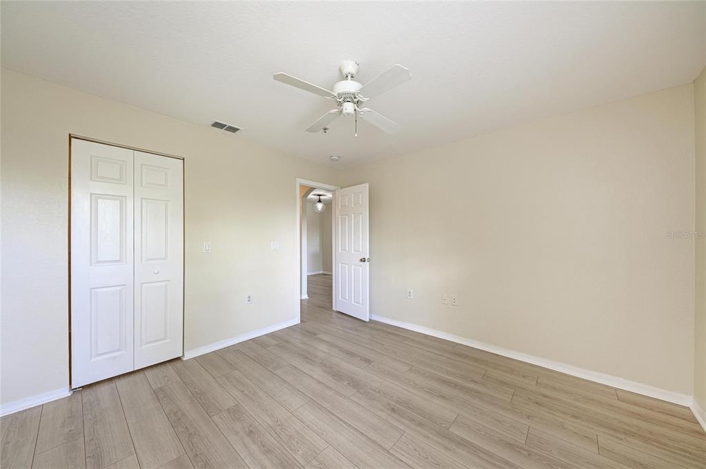 8911 Manor Loop, Unit 207 Lakewood Ranch, FL 34202 - Photo 35 of 71 a view of an empty room with wooden floor