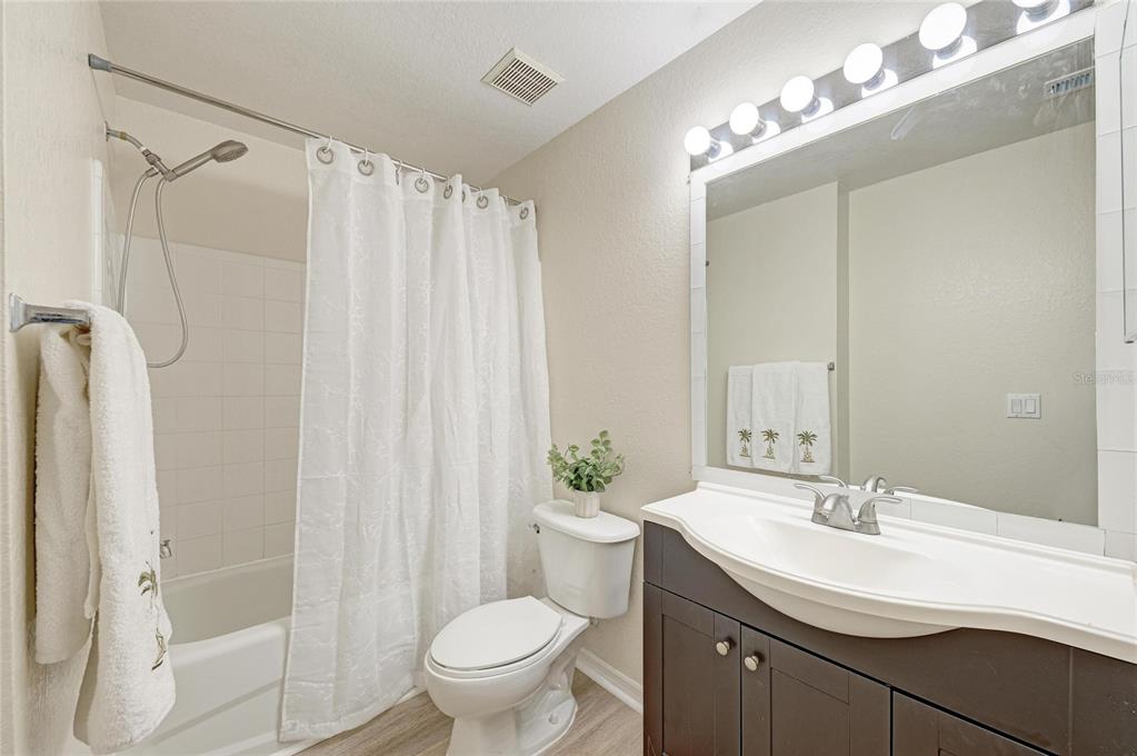 8911 Manor Loop, Unit 207 Lakewood Ranch, FL 34202 - Photo 39 of 71 a bathroom with a sink toilet a mirror and shower