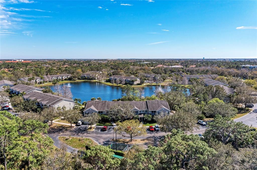 8911 Manor Loop, Unit 207 Lakewood Ranch, FL 34202 - Photo 4 of 71 an aerial view of a house with a yard and lake view
