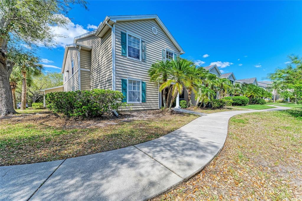 8911 Manor Loop, Unit 207 Lakewood Ranch, FL 34202 - Photo 6 of 71 a front view of a house with garden