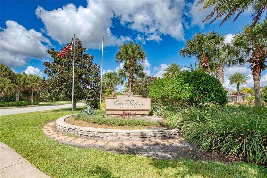 8911 Manor Loop, Unit 207 Lakewood Ranch, FL 34202 - Photo 61 of 71 a view of a house with a yard and coconut trees