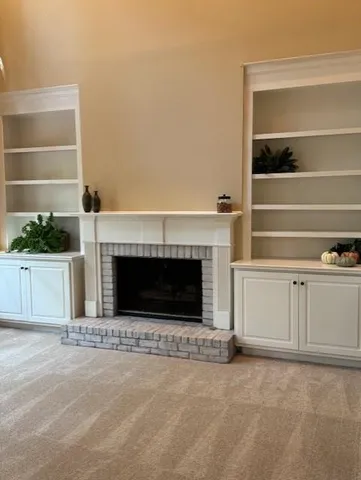 a view of a livingroom with an empty space and a fireplace