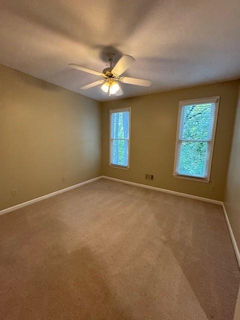 4055 Vista Point Lane Suwanee, GA 30024 - Photo 20 of 39 an empty room with windows and fan