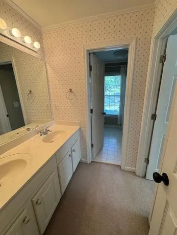 a spacious bathroom with a double vanity sink and a mirror