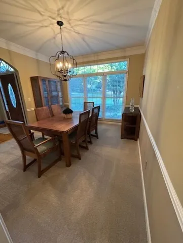 a view of a dining room with furniture wooden floor and chandelier