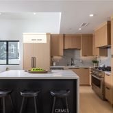 a kitchen with a sink refrigerator and cabinets
