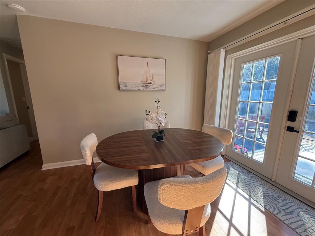 3066 19th Place Southwest Largo, FL 33774 - Photo 12 of 18 a view of a dining room with furniture window and wooden floor
