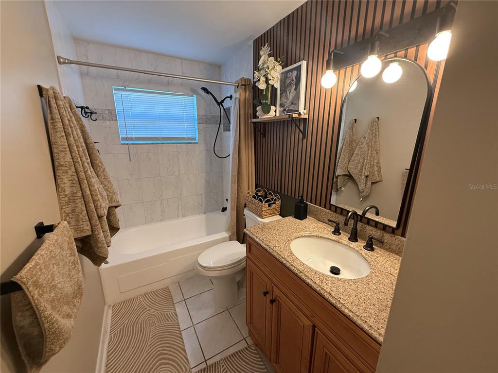 3066 19th Place Southwest Largo, FL 33774 - Photo 14 of 18 a bathroom with a sink a toilet and a mirror