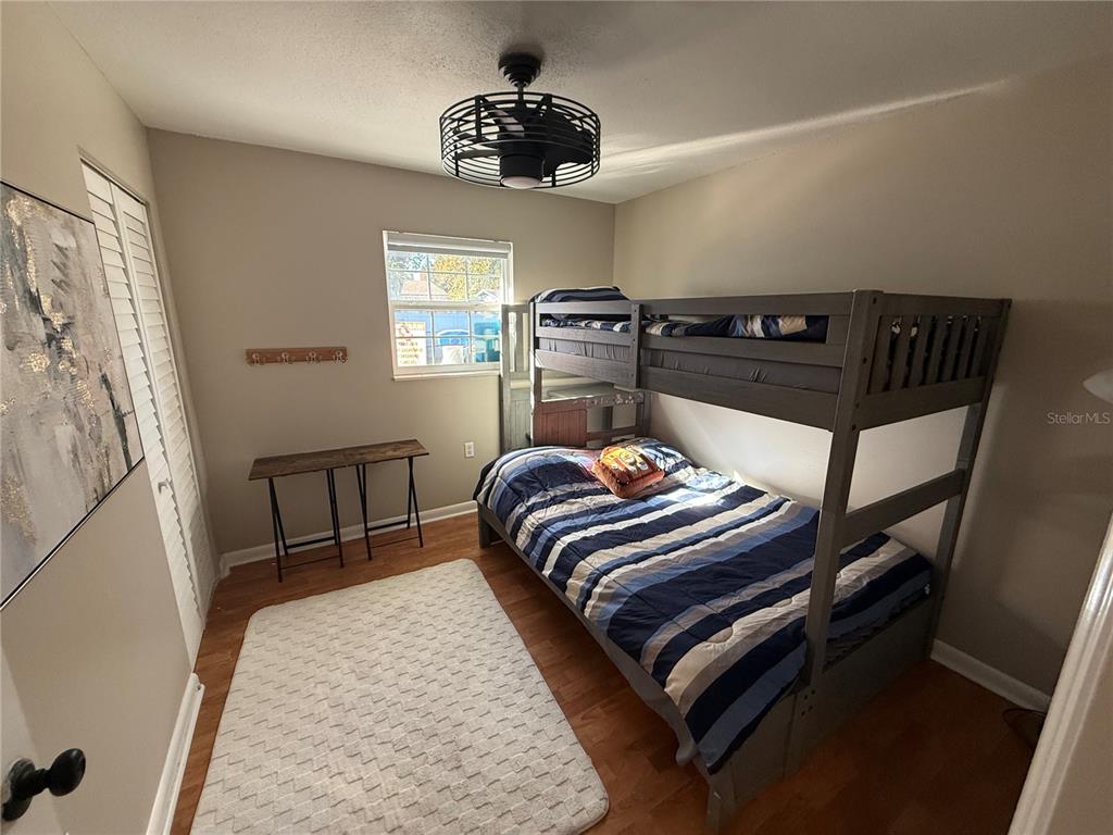 3066 19th Place Southwest Largo, FL 33774 - Photo 15 of 18 a bedroom with a bed and wooden floor