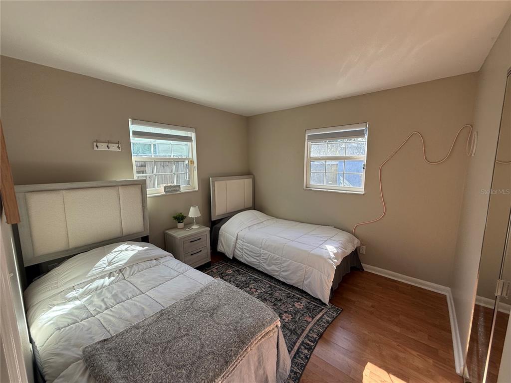 3066 19th Place Southwest Largo, FL 33774 - Photo 16 of 18 a bedroom with two beds and a window