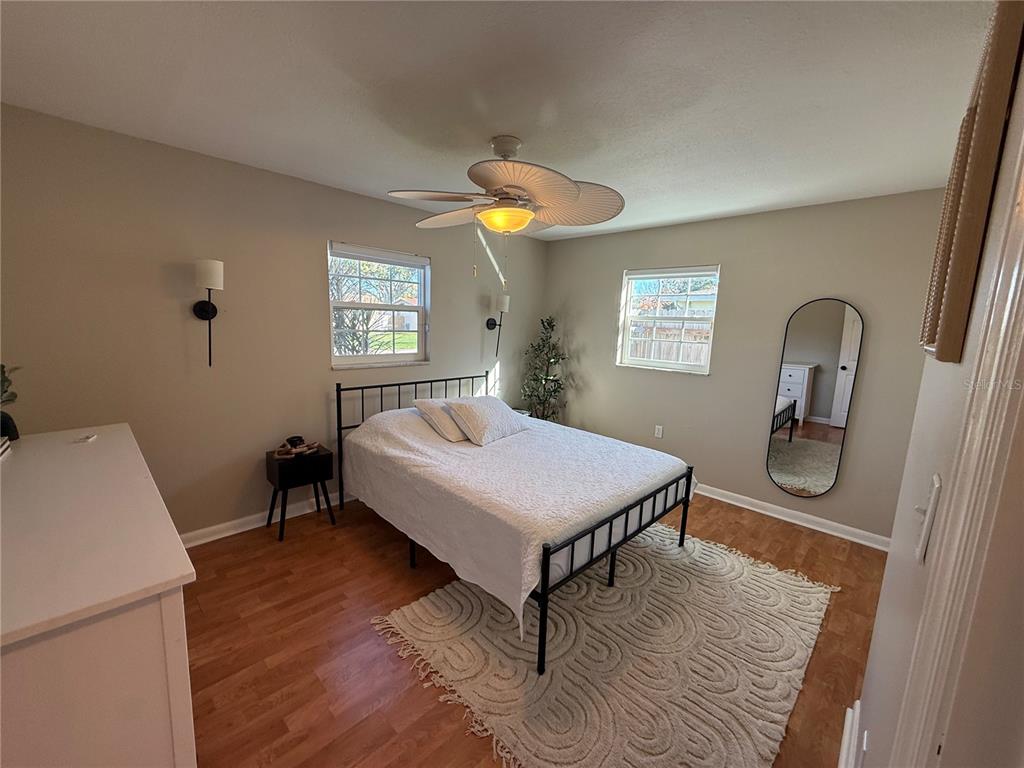 3066 19th Place Southwest Largo, FL 33774 - Photo 18 of 18 a bedroom with a bed and a mirror on the dresser