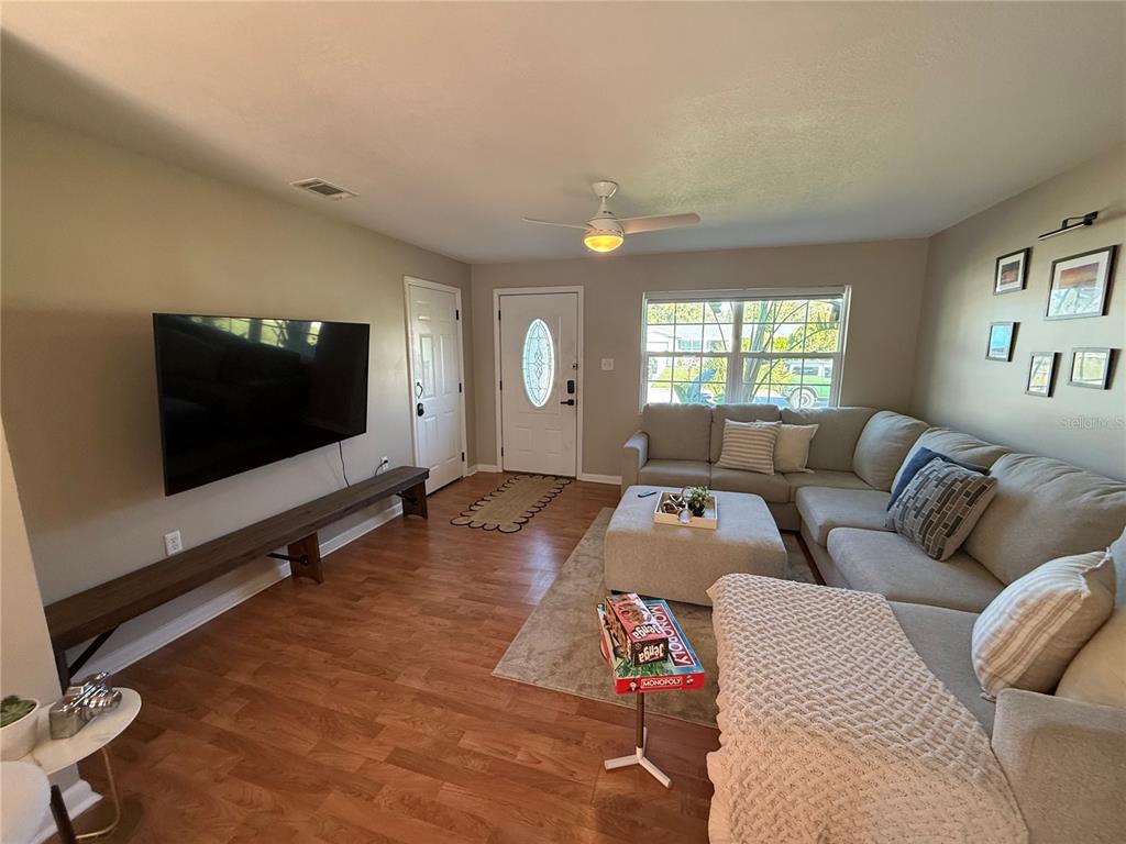 3066 19th Place Southwest Largo, FL 33774 - Photo 7 of 18 a living room with furniture and a flat screen tv