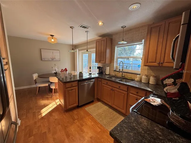 a kitchen with a sink stove and cabinets