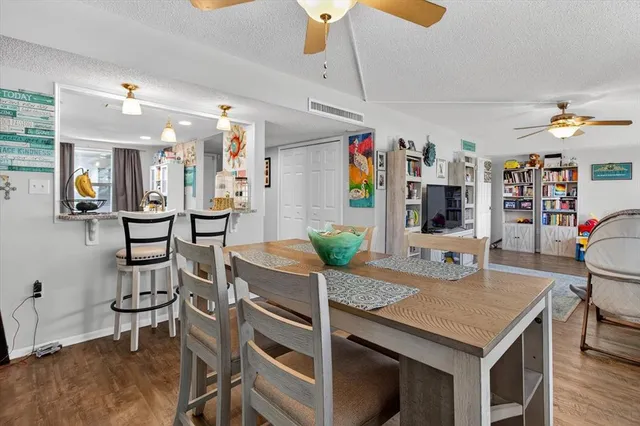 a living room with furniture and a flat screen tv with wooden floor