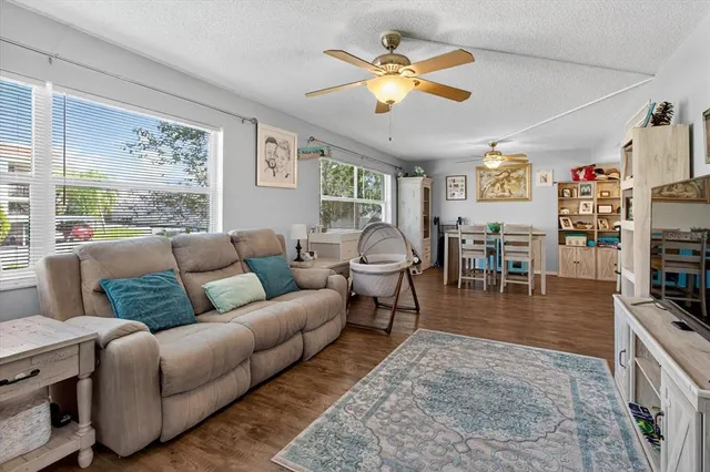 a bedroom with a bed and teddy bear on bed