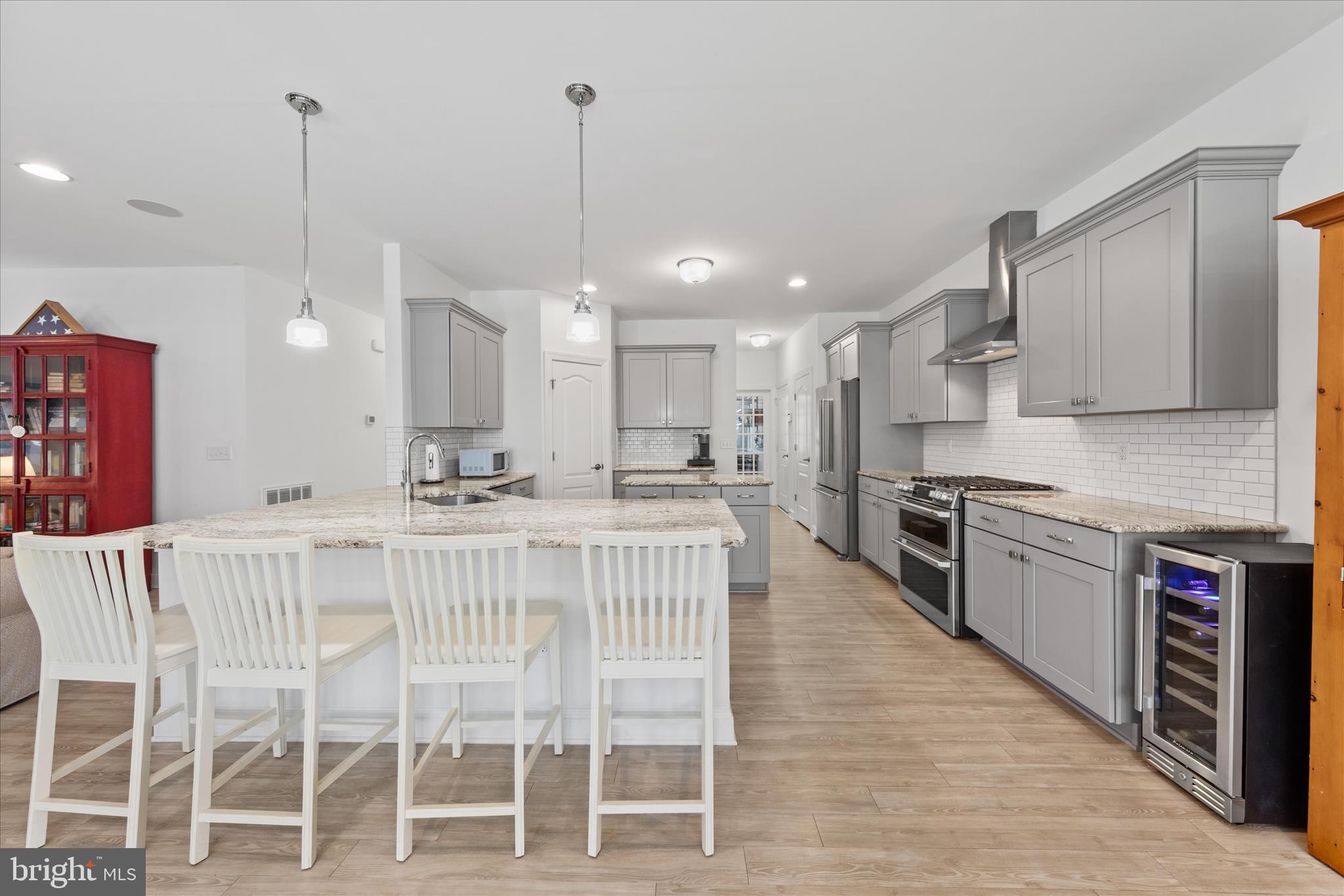19181 Alcott Way Georgetown, DE 19947 - Photo 2 of 41 a kitchen with stainless steel appliances kitchen island granite countertop a table chairs sink and cabinets