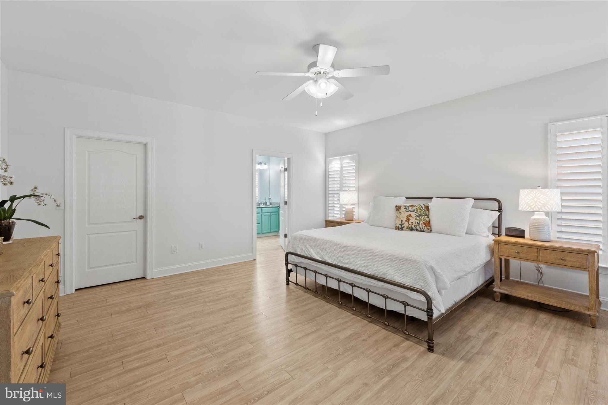 19181 Alcott Way Georgetown, DE 19947 - Photo 7 of 41 a spacious bedroom with a bed and a chandelier