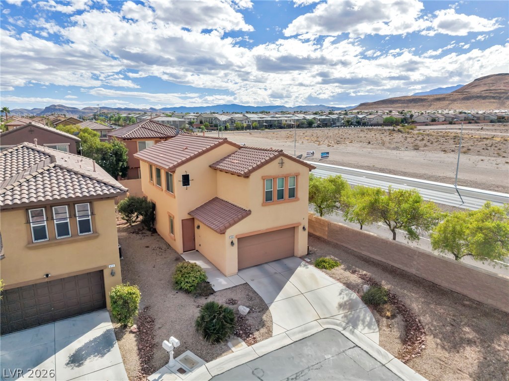 389 Fringe Ruff Drive Las Vegas, NV 89148 - Photo 31 of 53 Spanish tile roofs and a concrete driveway define this modern desert home with mountain views.