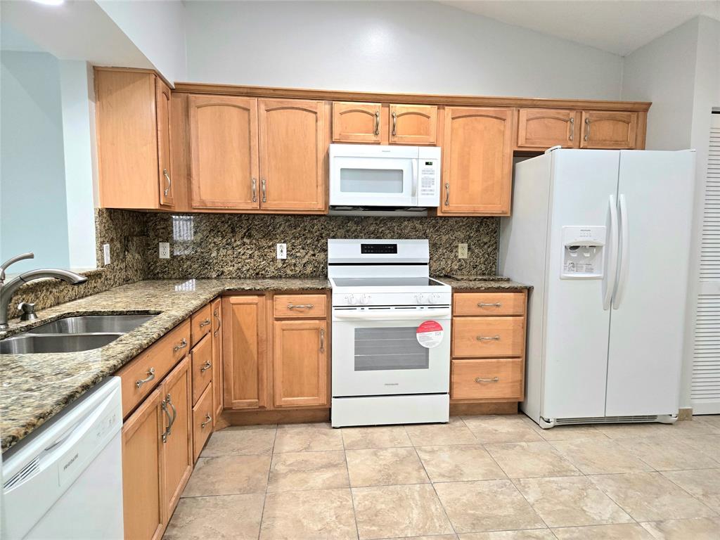 5912 Northwest 93rd Terrace Tamarac, FL 33321 - Photo 13 of 29 a kitchen with appliances cabinets and a sink