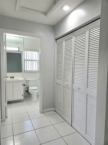 a white toilet sitting next to a bathroom sink