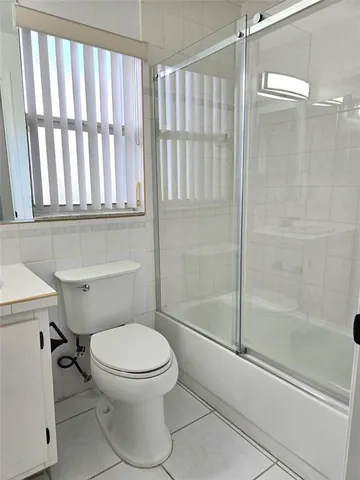 a bathroom with a toilet sink and shower