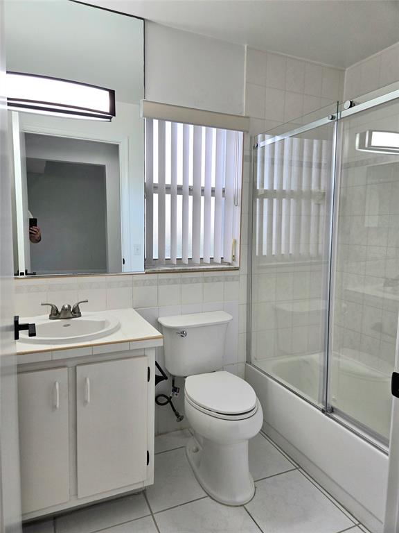 5912 Northwest 93rd Terrace Tamarac, FL 33321 - Photo 17 of 29 a bathroom with a toilet sink and shower