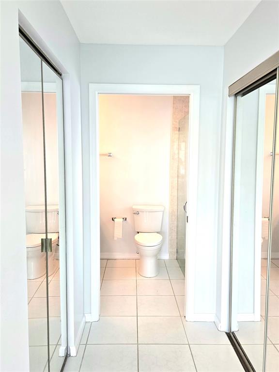 5912 Northwest 93rd Terrace Tamarac, FL 33321 - Photo 23 of 29 a bathroom with a toilet a sink and a large mirror