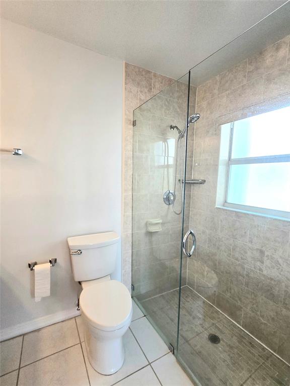5912 Northwest 93rd Terrace Tamarac, FL 33321 - Photo 24 of 29 a bathroom with a toilet and a shower