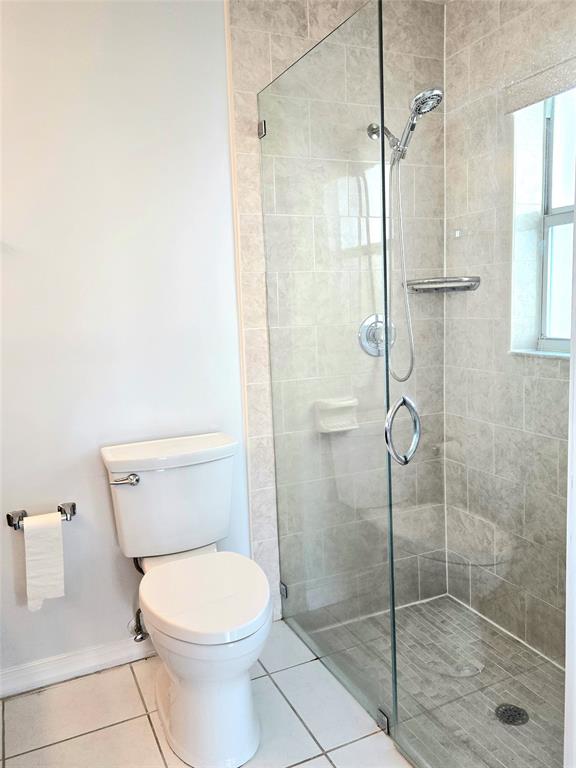 5912 Northwest 93rd Terrace Tamarac, FL 33321 - Photo 25 of 29 a bathroom with a toilet and shower