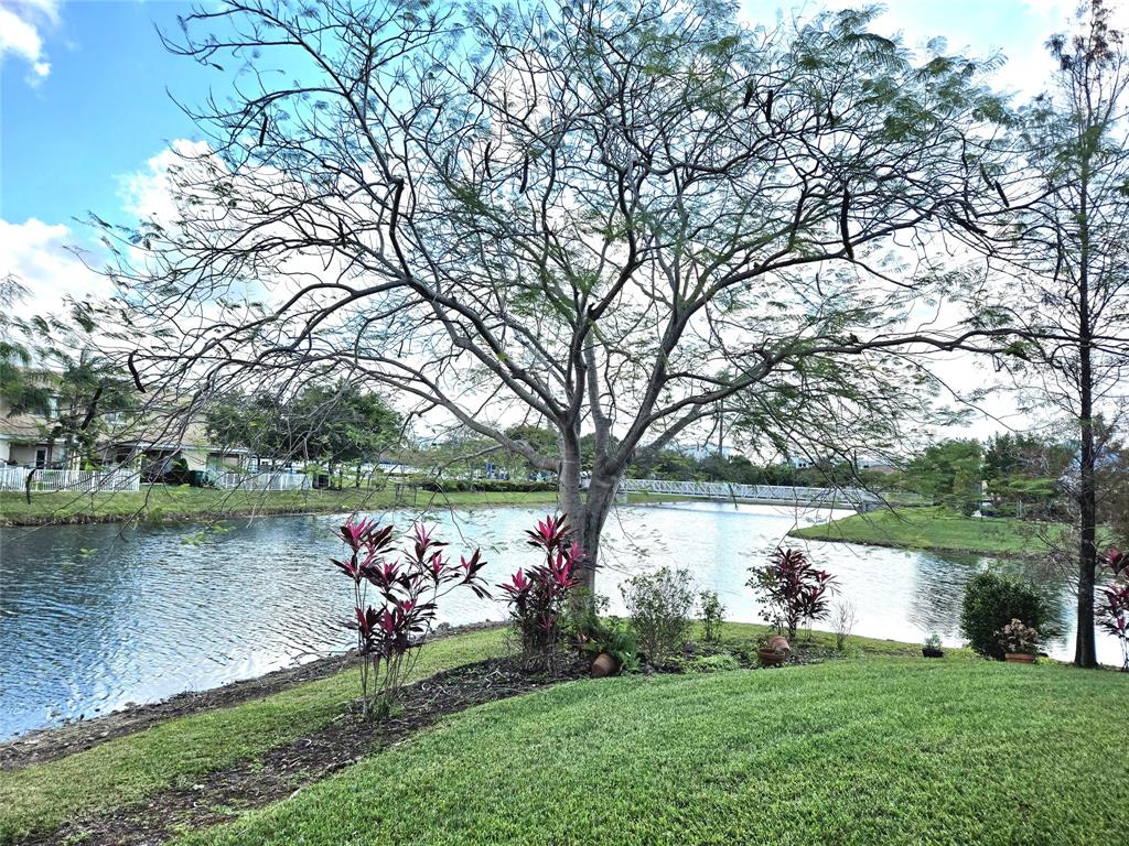 5912 Northwest 93rd Terrace Tamarac, FL 33321 - Photo 29 of 29 a lake view with a bench and trees around