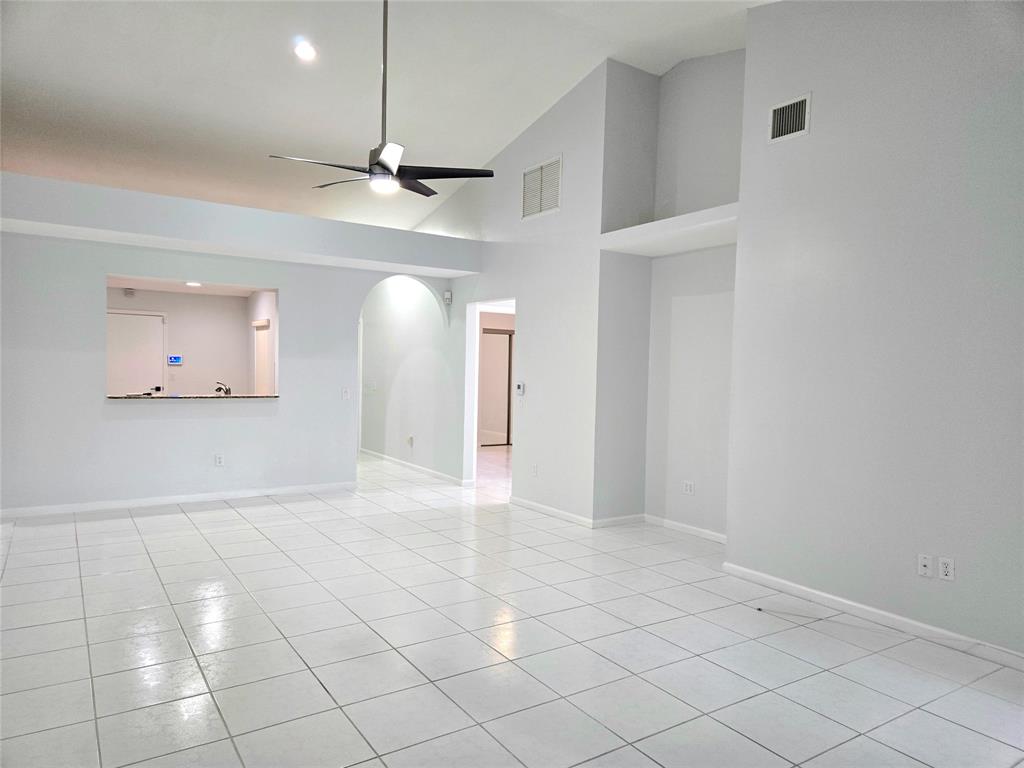 5912 Northwest 93rd Terrace Tamarac, FL 33321 - Photo 8 of 29 a view of an empty room and window ceiling fan