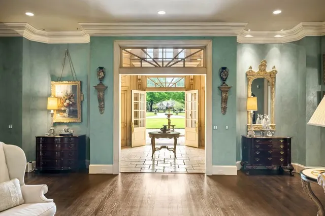 a living room with furniture large window and fireplace