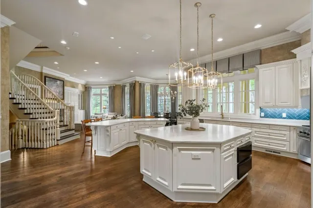 a living room with furniture a large window and a fireplace