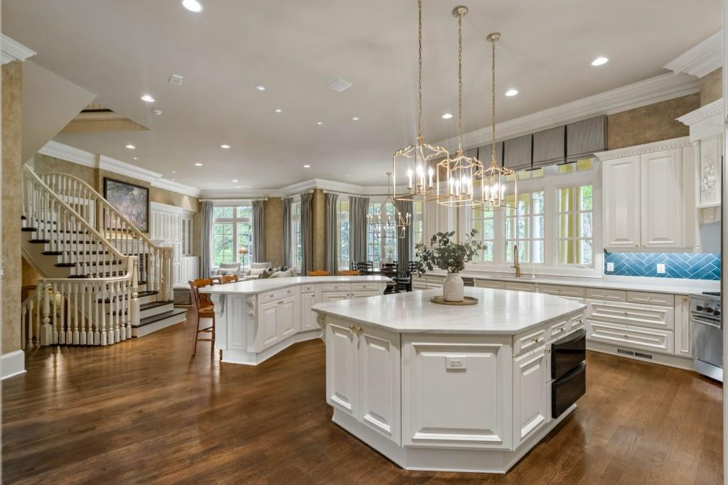10955 Stroup Road Roswell, GA 30075 - Photo 13 of 73 a kitchen with stainless steel appliances granite countertop a sink a stove and a wooden floors