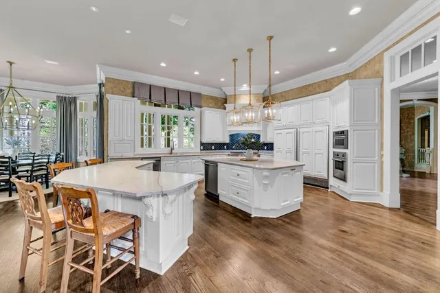 a view of a dining room with furniture and chandelier