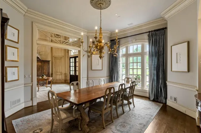 a living room with fireplace furniture and a floor to ceiling window