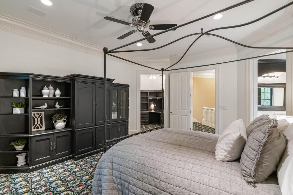 10955 Stroup Road Roswell, GA 30075 - Photo 45 of 73 a bedroom with a bed cabinets and walk in closet