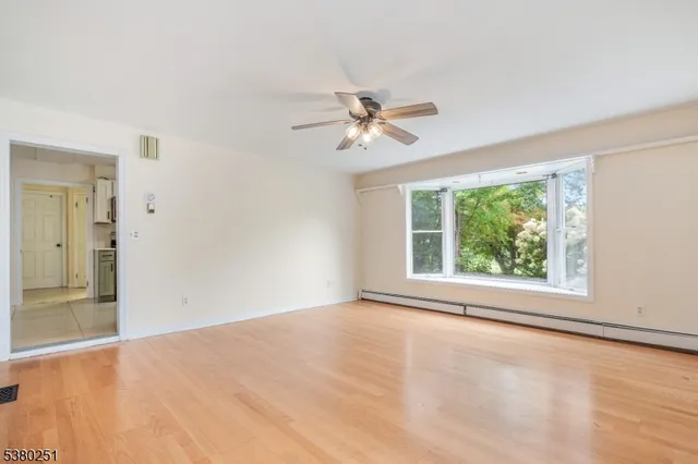 wooden floor in an empty room with a window