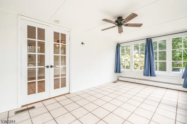 a view of a livingroom with a ceiling fan and window