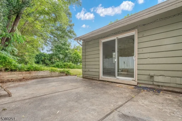 a view of a house with a backyard and floor to ceiling window