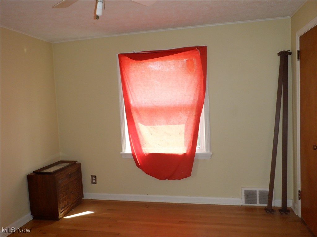4105 Wyncote Road South Euclid, OH 44121 - Photo 7 of 30 Unfurnished room with hardwood / wood-style floors, a wealth of natural light, and ceiling fan