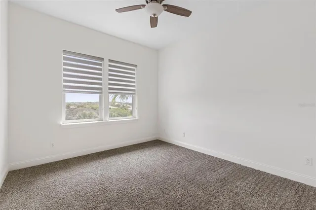 an aerial view of a house with a yard and lake view
