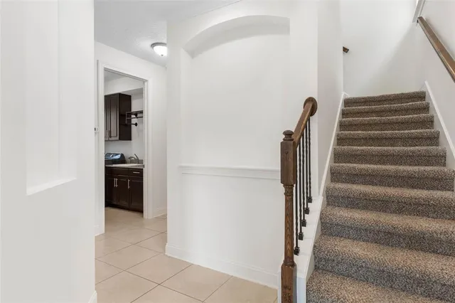 a view of an empty room with a window and a ceiling fan